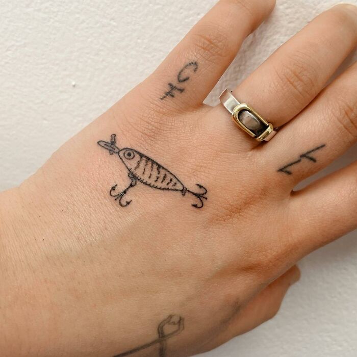 Black crank bait tattoo on hand