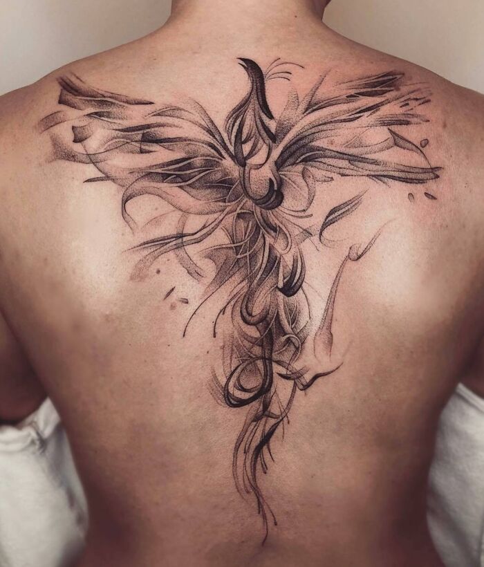 Abstract large phoenix bird tattoo on back