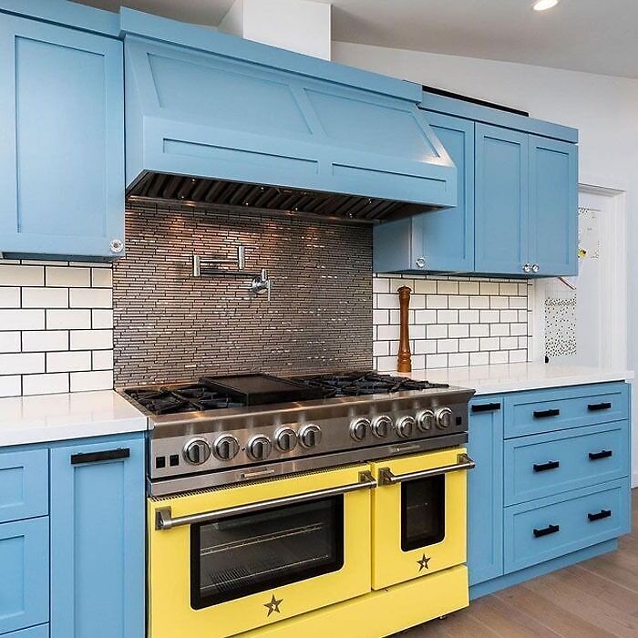 Light blue kitchen cabinets with yellow owen