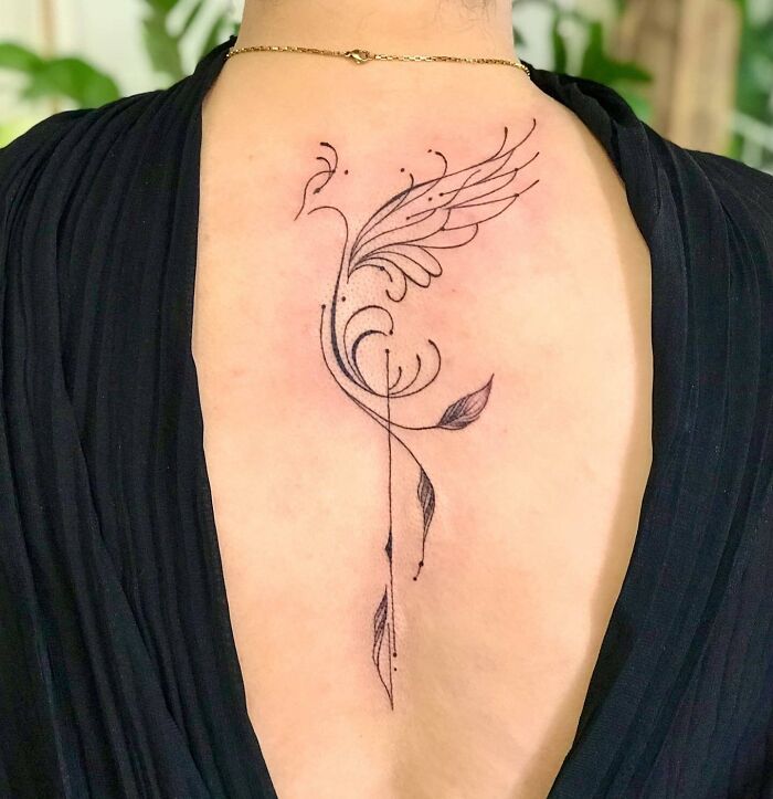 Black linear bird spine tattoo