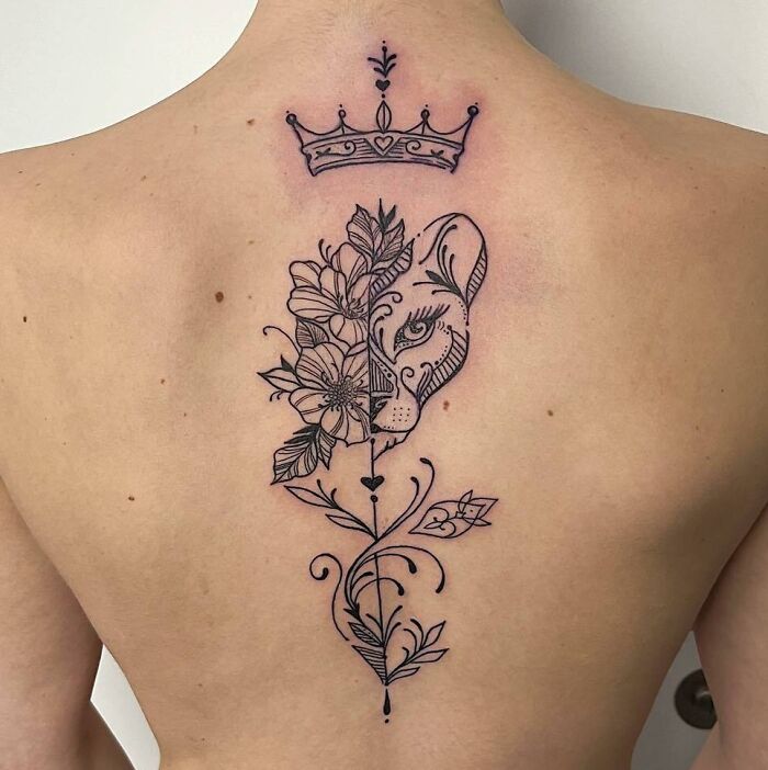 Face - half lion, half flowers, and a crown on top tattoo on back