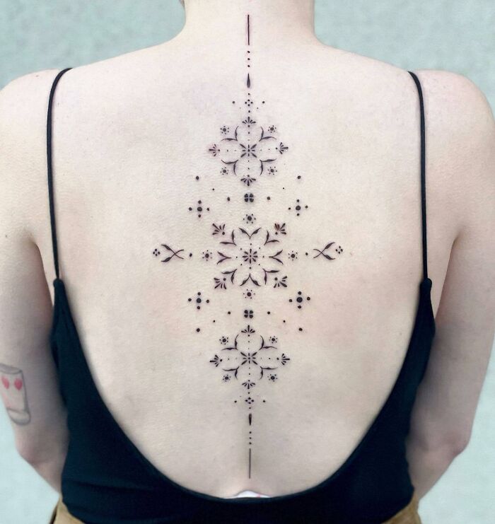 Black minimal abstract spine tattoo