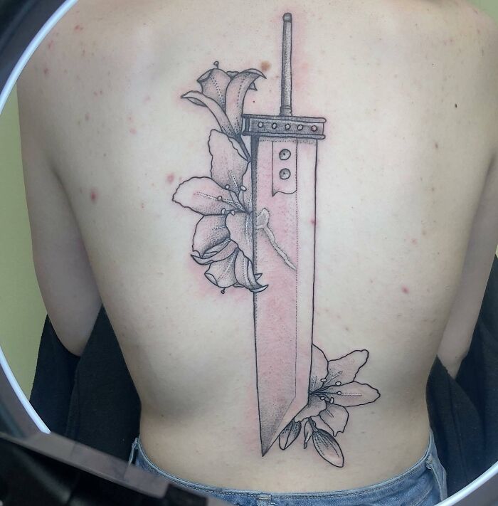 Clouds sword from Final Fantasy 7 and flowers tattoo on the spine