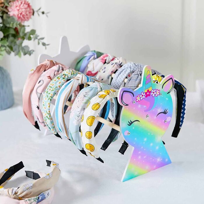 Girly headband holder with rainbow unicorn and many headbands organized