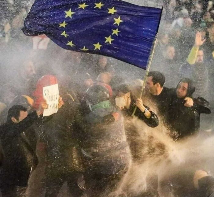 This Really Ticks All The Boxes, The Guy Holding The Poster, The Other Sticking Out From The Fog In The Back And The Perfectly Exposed Flag