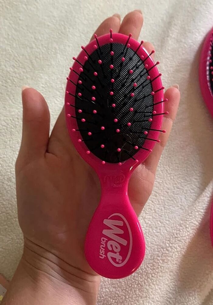 Wet Brush Mini Detangler: The pro at gliding through my tangled mess, regardless of whether your hair is oily, dry, or normal. This pink pocket-sized companion makes getting rid of knots effortless, and *trust me,* it's a total hair-savoir.