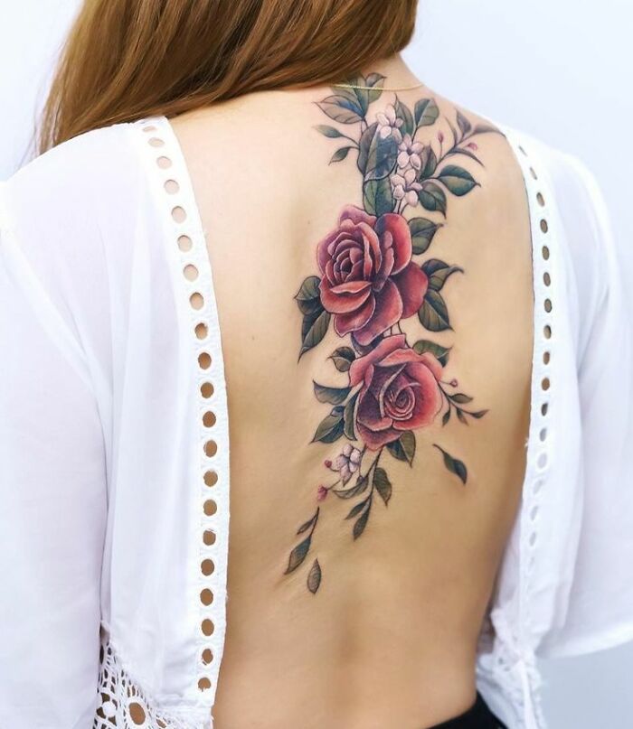 Two red roses tattoo on the spine