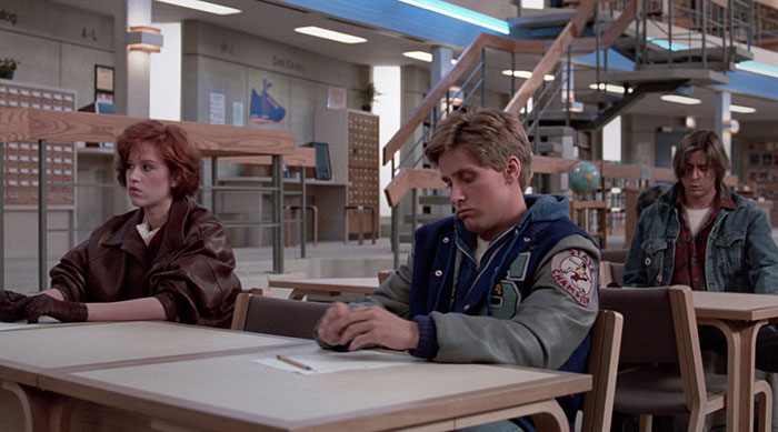 Woman and two man sitting in a class room 