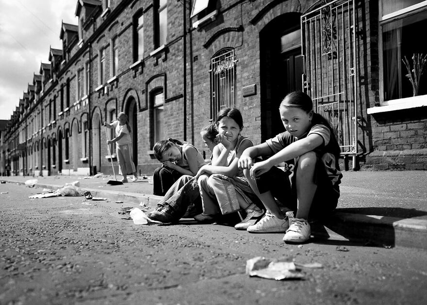 Belfast, Shankill. Girls Sitting On The Sidewalk Of Tennent Street From The Series 'Wee Mcukers – Youth Of Belfast' By Toby Binder