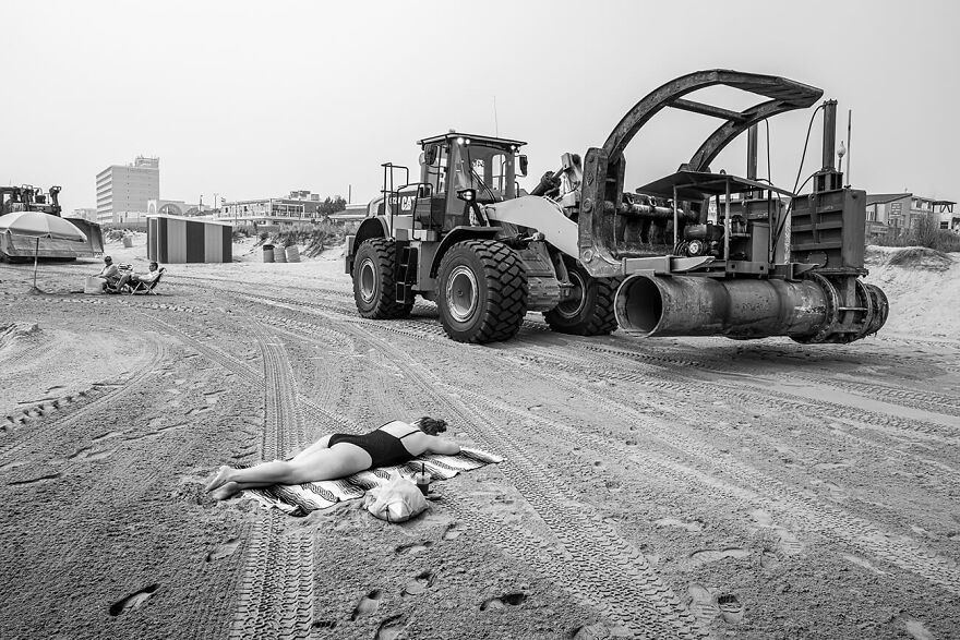 Sunbathing Amongst The Heavy Machinery From The Series 'Moments Of Synchronicity' By Prescott Lassman