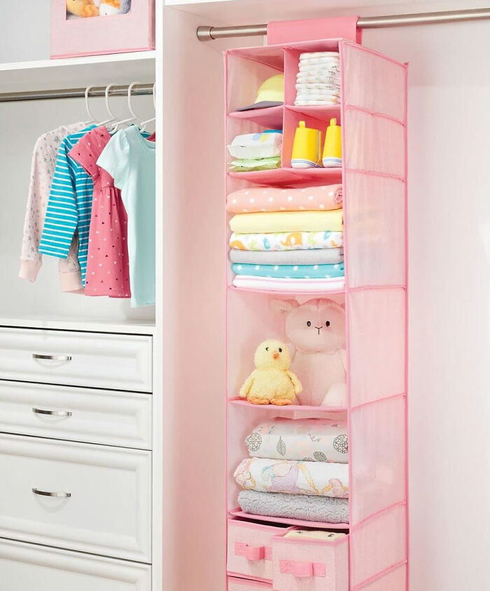 Soft fabric pink hanging storage in closet with toys and clothes in it