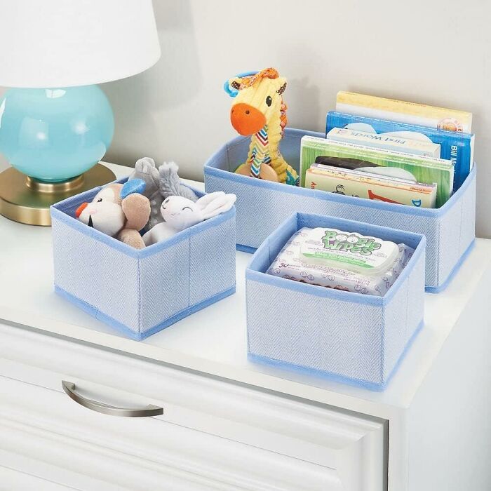 Soft fabric blue storage bins with toys and books