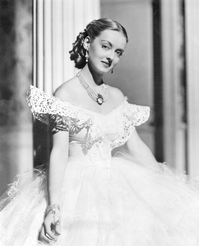Bette Davis posing with a white wedding dress 