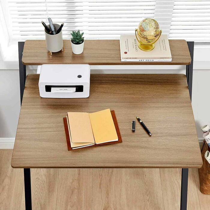 Foldable brown wooden study desk with printer and books on it