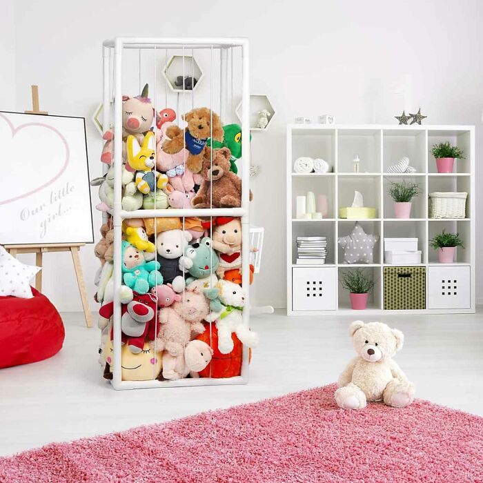 White rectangle animal zoo storage with elastic bands and many colorful stuffed animal toys