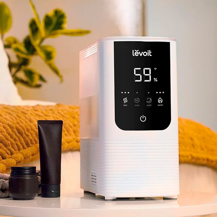 Humidifier on the table near the tubes of cream