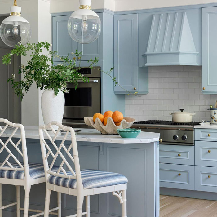 Light blue kitchen cabinets with chairs
