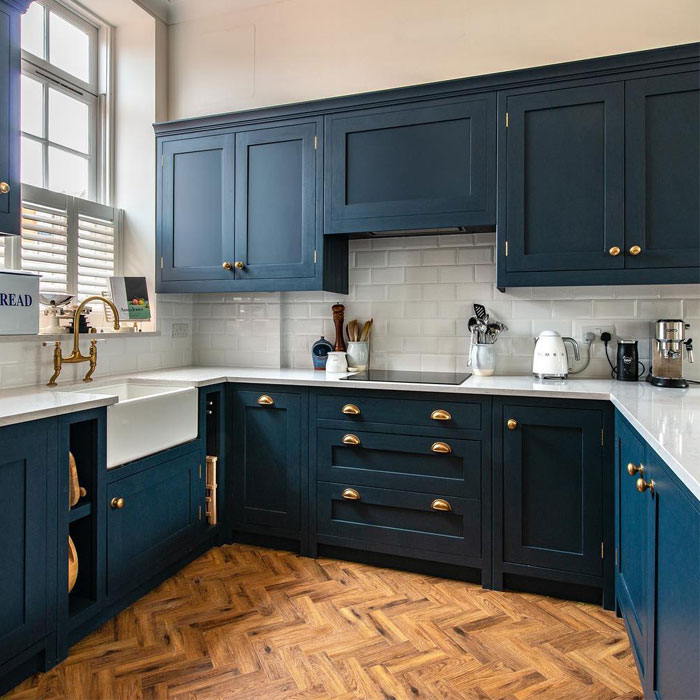 Dark blue kitchen cabinets with white tiles
