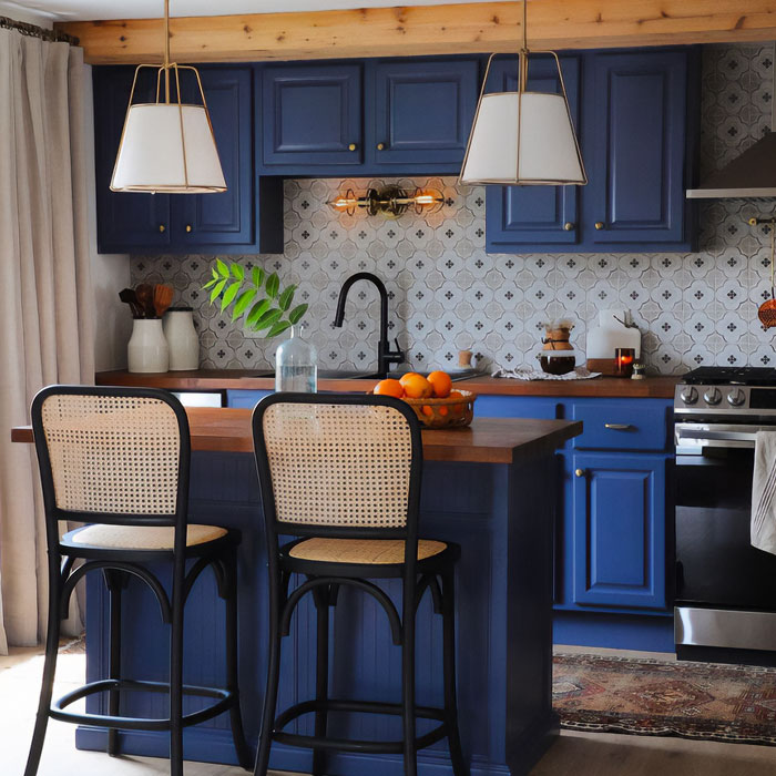 Dark blue kitchen cabinets with chairs and table