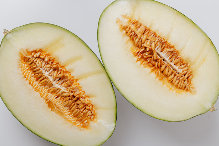 Sliced cantaloupe halves, showcasing seeds and juicy interior, exploring if dogs can eat this fruit. Sliced cantaloupe halves, showcasing seeds and juicy interior, exploring if dogs can eat this fruit.
