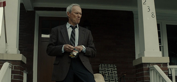 Clint Eastwood walking down the stairs and eating 