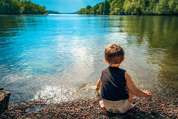 Child playing near the lake