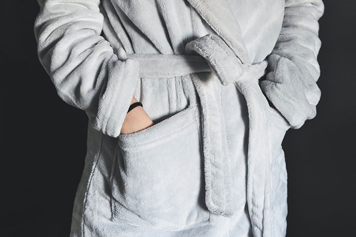 Person's hands Inside bathrobe pockets