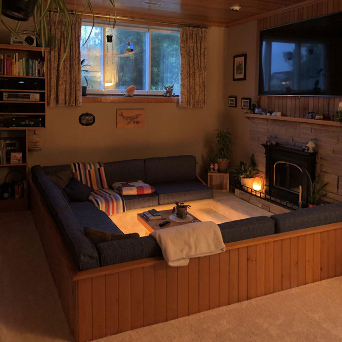 Cozy conversation pit with a TV and a fireplace