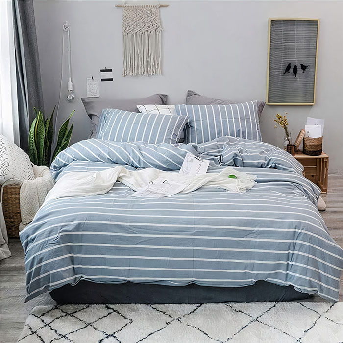 Cerulean colored bed sheets on a bed 
