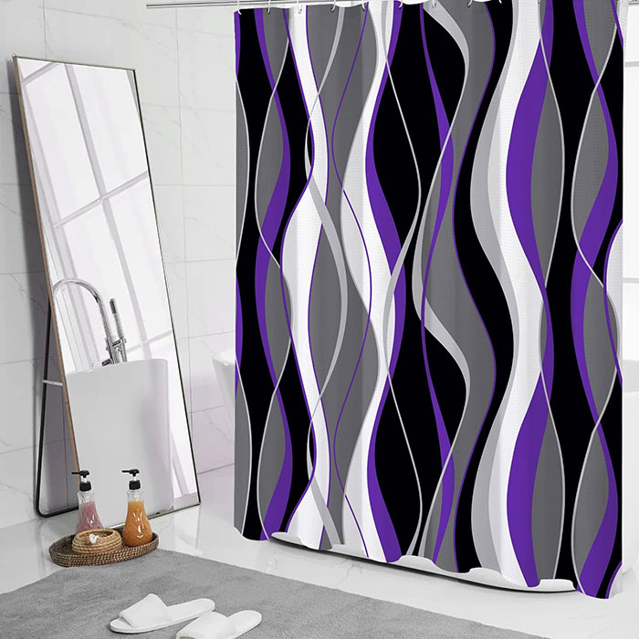 Purple gray and white colored shower curtain in a white bathroom 