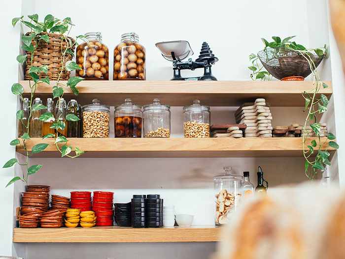 Wooden Shelves with Glass Jars Filled with Various Ingredients