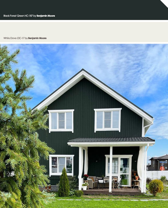 Dark green exterior house with white trim and porch, showcasing one of the top exterior house colors to turn heads.