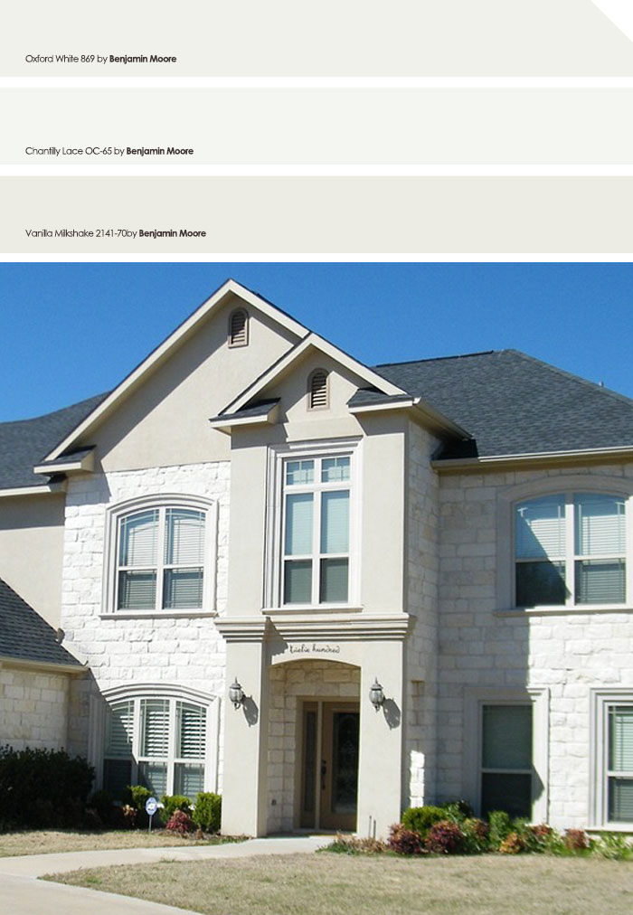 White exterior house with stone accents and large windows, showcasing a popular exterior house color for neighborhood appeal