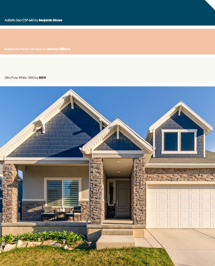 Blue and grey exterior house colors featuring stone accents, modern design, and a welcoming front porch in a sunny neighborhood setting