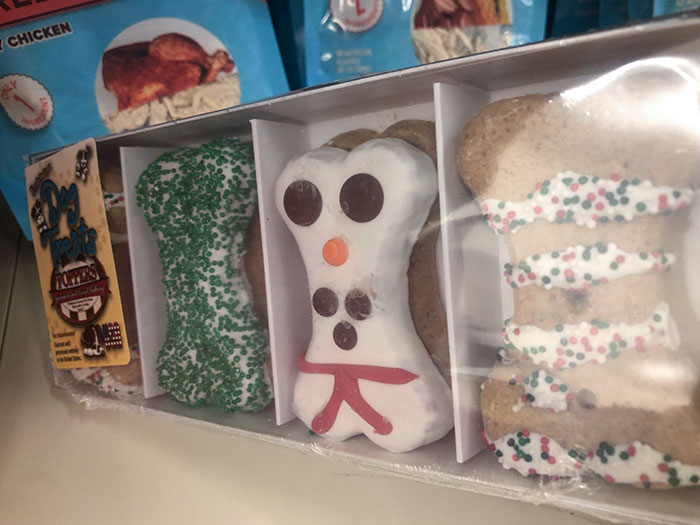 This Box Of Dog Treats That Very Obviously Don’t Have Frosting Designs On The Cookies Behind The Top Layer