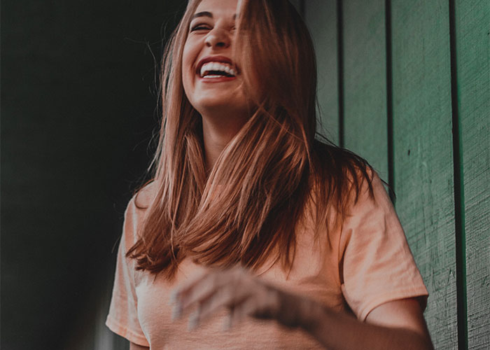 Woman laughing joyfully indoors, highlighting man freaking out over baby’s hair color and paternity test results. Woman laughing joyfully indoors, highlighting man freaking out over baby’s hair color and paternity test results.