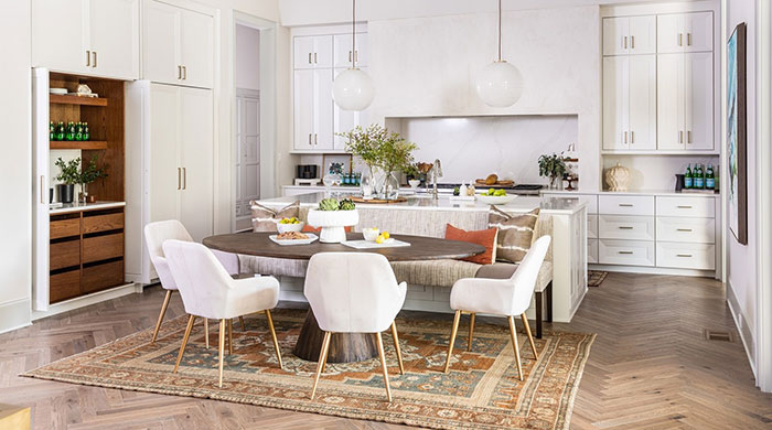 Kitchen island and a dining table near it in a bright kitchen 