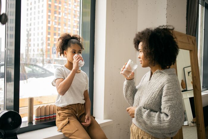 Mom and her daughter talking and drinking water 