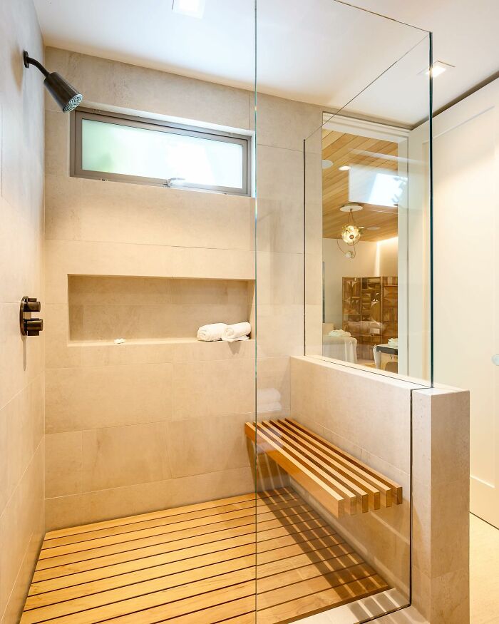 SPA like walk-in shower with a wooden bench 