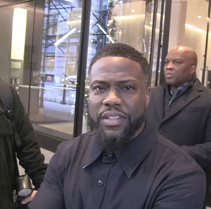 A person outside a building entrance, wearing a dark coat, discussing Greta Gerwig's response to Jo Koy's Barbie joke. A person outside a building entrance, wearing a dark coat, discussing Greta Gerwig's response to Jo Koy's Barbie joke.