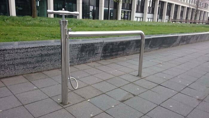 A Public Bike Stand With A Built-In Pump