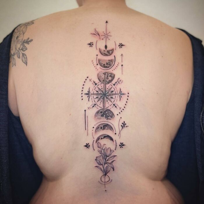 Moon phases and compass spine tattoo