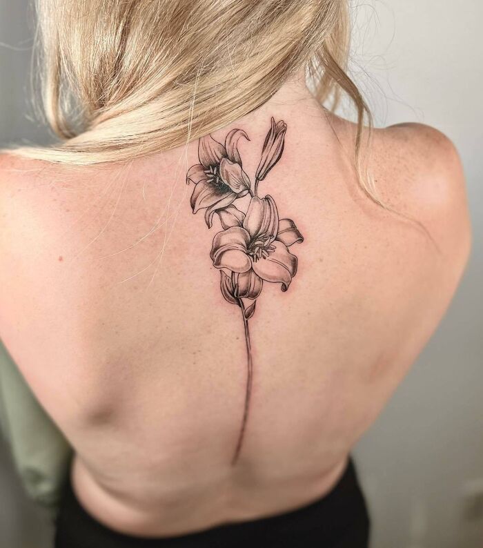Lilly tattoo on spine