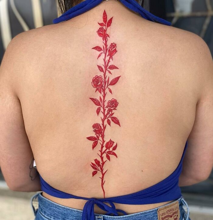 Red rose spine tattoo