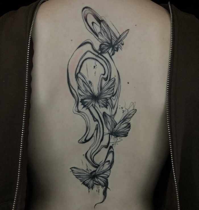 Four butterflies with abstract lines tattoo on the back