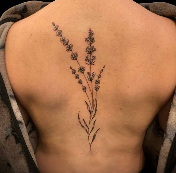 Lavender branch tattoo on spine