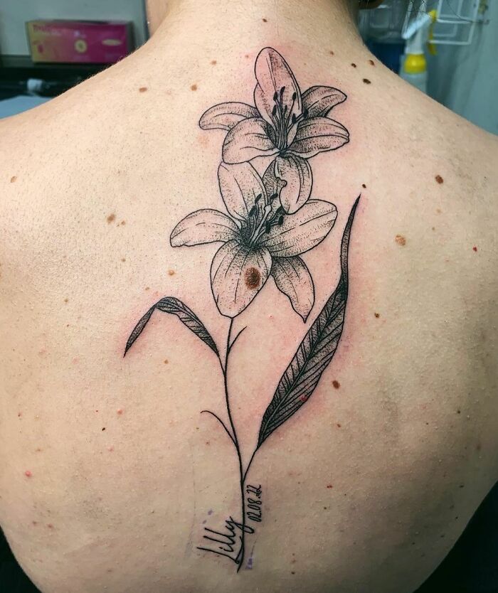 Two lilies spine tattoo