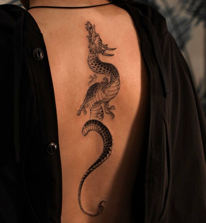 Black dragon tattoo on back