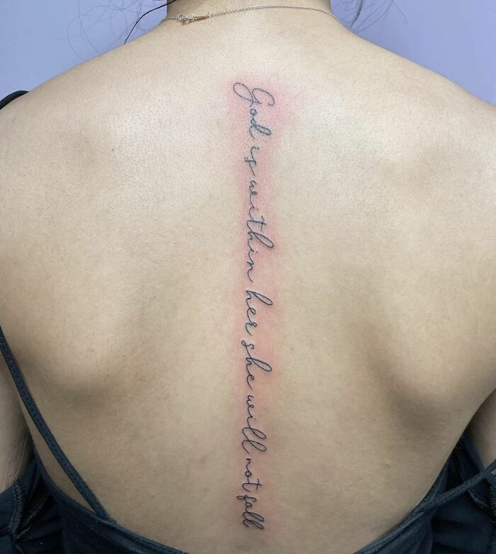 Lettering spine tattoo