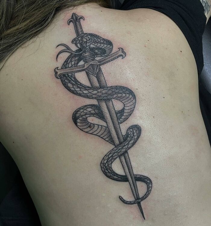 Snake and sword back tattoo